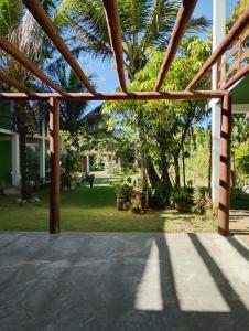 an open patio with a view of a yard at Pousada Kaa - Natureza e Sossego em Itacaré in Itacaré
