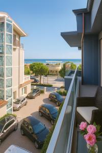 a balcony with cars parked in a parking lot at Frontemare Appartamenti e Camere ELISABETTA in Cesenatico