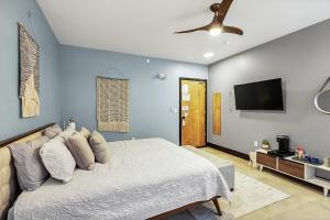 a bedroom with a bed and a flat screen tv at Relaxing king suite with jacuzzi and pool in Pacific