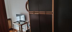 a black refrigerator in a room with a table at Oleggio apartment in Oleggio