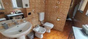 a bathroom with a sink and a toilet and a sink at Oleggio apartment in Oleggio