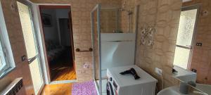 a small bathroom with a shower and a sink at Oleggio apartment in Oleggio