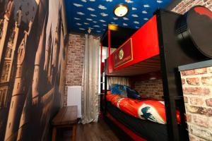 a room with a bed and a brick wall at Quidditch Quarters Themed Property in Garston