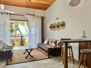a living room with a couch and a table at South Coast Villas by Mandala in Tangalle