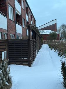 a sidewalk covered in snow next to a brick building at Wilder Klaus in Wangerooge +10 photos