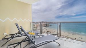 a balcony with chairs and a view of the beach at Elegant Beachfront Getaway with Unmatched Views in Puerto Peñasco