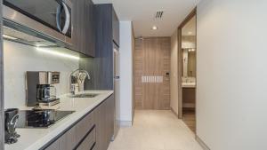 a kitchen with a sink and a counter top at Elegant Beachfront Getaway with Unmatched Views in Puerto Peñasco