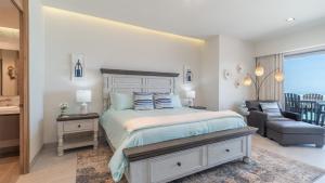 a bedroom with a bed and a couch and a chair at Modern Seaside Retreat Boasting Unforgettable Scenery in Puerto Peñasco +21 photos
