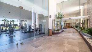 a gym with glass walls and a lobby with exercise equipment at Elegant Ocean Getaway Designed for Relaxation and Luxury in Puerto Peñasco