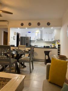 a kitchen and living room with a table and chairs at STEPS TO THE BEACH 2 Stunning condo 4 min walk to Bibijagua Beach and Catamarans in Punta Cana