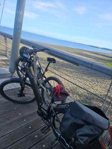 a bike parked on a boardwalk next to the beach at L'Aparté 2 vues in La Possession +9 photos