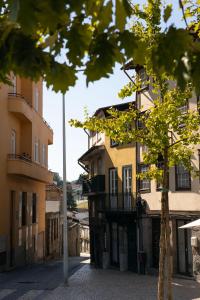 an empty street in a city with buildings at Bellu Suites by GuestPro in Guimarães