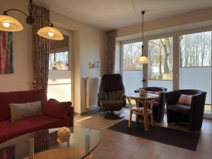 a living room with a couch and chairs and a table at Ferienhaus in Lindern mit Garten & Terrasse in Werlte