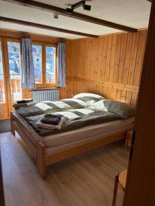 a bedroom with a large bed in a room at Alte Bock 2.0 in Grächen