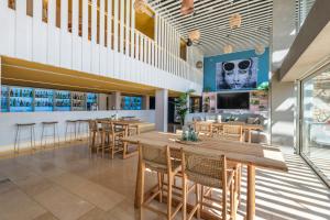 a dining room with tables and chairs in a restaurant at Leonardo Boutique Hotel Mallorca Port Portals - Adults only in Portals Nous