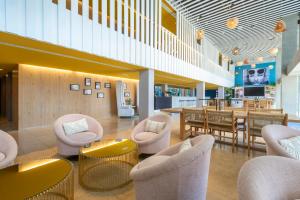 a lobby with chairs and tables and a restaurant at Leonardo Boutique Hotel Mallorca Port Portals - Adults only in Portals Nous