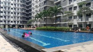 people swimming in a swimming pool in a building at The Turianos in Manila