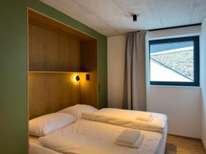 a bedroom with two beds and a window at Apartmán Ore&Moor in Boží Dar