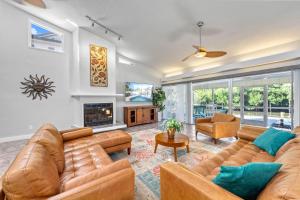 a living room with couches and a fireplace at Siesta SunDaze - 5430 in Sarasota