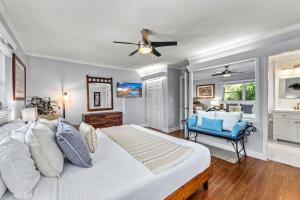 a bedroom with a bed and a blue chair at Siesta SunDaze - 5430 in Sarasota +39 photos