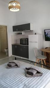 a room with a bed and a chair and a microwave at Афіни Лофт in Piraeus