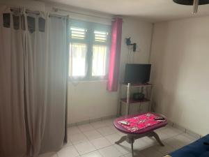 a living room with a table and a window at Kaz'a Diamant in Le Diamant