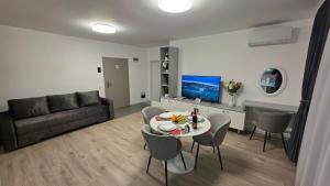 a living room with a couch and a table at Mountain View Apartment&Parking in Râşnov
