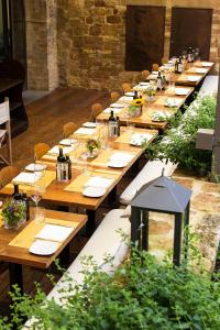 un lungo tavolo in legno con piatti e bicchieri da vino di La Bandita Townhouse a Pienza