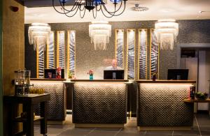 a man sitting at a bar in a restaurant at NYX Hotel Madrid by Leonardo Hotels in Madrid