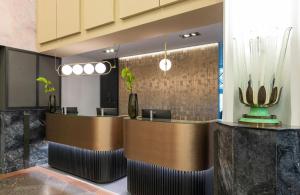 a lobby with two reception desks in a building at Leonardo Royal Hotel Berlin Alexanderplatz in Berlin
