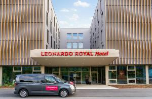 a small car parked in front of a building at Leonardo Royal Hotel Cologne Bonn Airport in Cologne