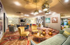 a lobby with couches and chairs and a table at Leonardo Hotel Mannheim-Ladenburg in Ladenburg