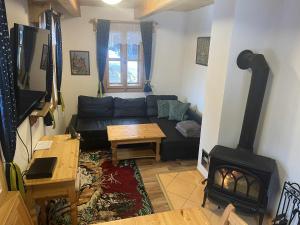 a living room with a couch and a fireplace at Statek U Rajmunda zemědělská farma in Velké Karlovice