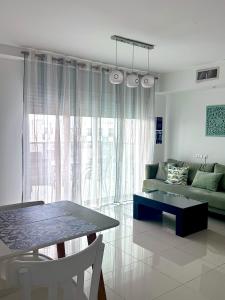 a living room with a couch and a table at Royal Park A&7 Deluxe, swim pool - by G&P suites in Eilat