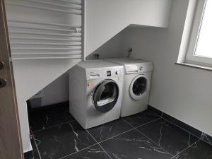 a washing machine and a washer in a room at Apartment house Petra in Cerklje na Gorenjskem