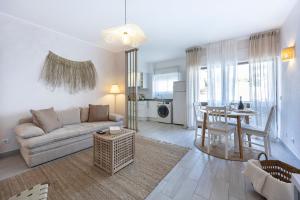 a living room with a couch and a table at Albufeira City Centre Apartment with Pool in Albufeira +8 photos
