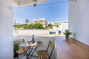 a table and chairs on a balcony with a view of the ocean at Albufeira City Centre Apartment with Pool in Albufeira