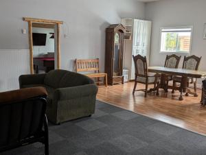 a living room with a couch and a table and chairs at Twin Peaks Hotel Cabins in Valemount