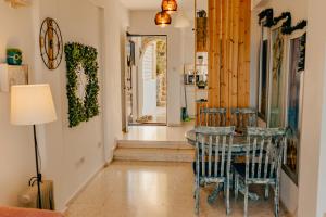 a dining room with a table and chairs at Two Bedroom Sea View Townhouse-Villa Libellula in Khlorakas +10 photos