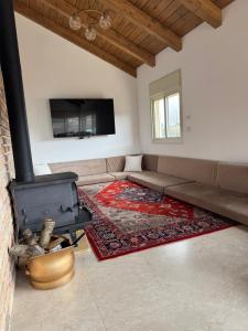 a living room with a couch and a fireplace at צימר בטבע in Majdal Shams +21 photos