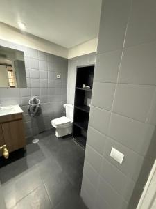 a bathroom with a toilet and a sink at Apartamentos Viva León in León +111 photos