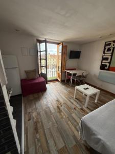 a room with a bed and a table and a desk at Apartamentos Viva León in León