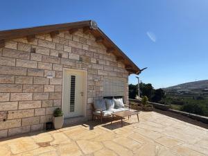 a stone building with a couch in front of it at צימר בטבע in Majdal Shams
