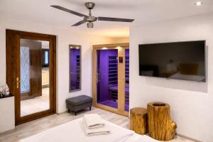 a bedroom with a bed and a tv on a wall at Penzion Pibernik in Bled