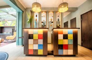 a lobby with colorful dividers in a store at Leonardo Boutique Hotel Berlin City South in Berlin