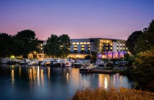 a marina with boats docked in front of a building at NYX Hotel Berlin Köpenick by Leonardo Hotels in Berlin