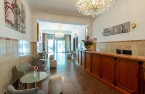 a lobby with a waiting area with a table and chairs at Leonardo Hotel Berlin KU'DAMM in Berlin