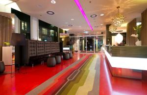 a lobby with a colorful floor in a building at Leonardo Hotel Berlin Mitte in Berlin