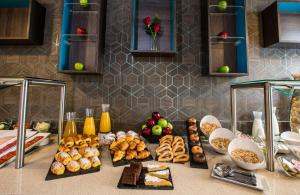 a counter with a bunch of different types of food at Leonardo Boutique Hotel Madrid in Madrid