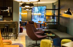 a lobby with a couch and chairs and a bar at Leonardo Boutique Hotel Madrid in Madrid +29 photos